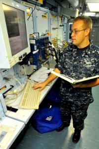 US Navy 110722-N-EE987-045 Aviation Electronics Technician 2nd Class Matt Mitton, from Helena, Mont., uses a consolidated automated support system