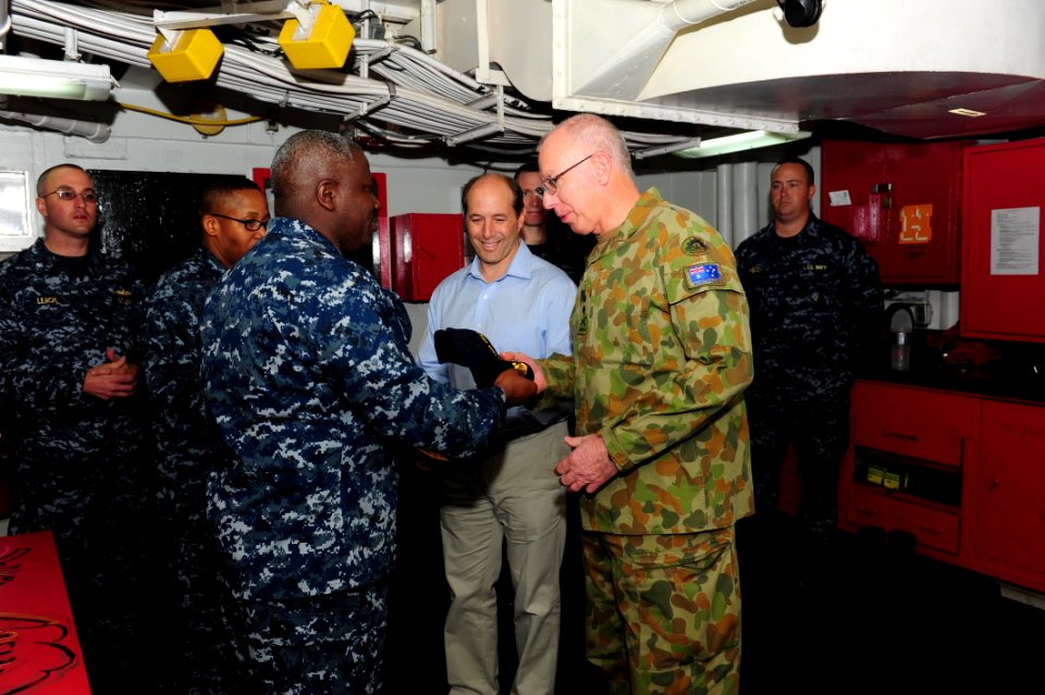 US Navy 110722-N-WA347-126 Cmdr. A. D. Hull presents the command ball cap and command coin to Australian Army Gen. David Hurley, chief of Defence F