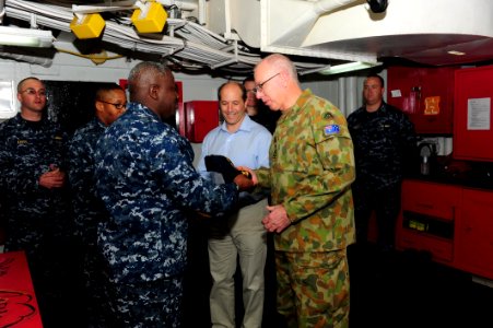 US Navy 110722-N-WA347-126 Cmdr. A. D. Hull presents the command ball cap and command coin to Australian Army Gen. David Hurley, chief of Defence F