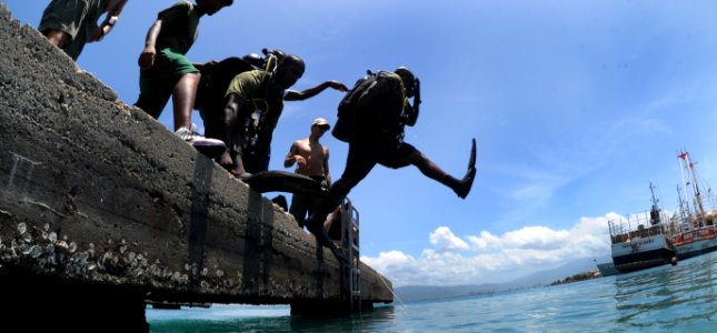 US Navy 110726-N-XD935-149 A diver from the Jamaican Coast Guard enters the water using the front water step entry method during joint diving opera