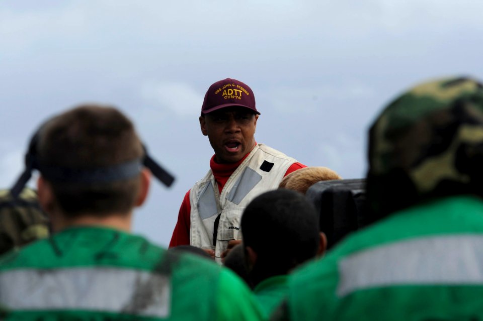 US Navy 110726-N-ZZ999-044 Lt. j.g. Kenyatto Mayes gives a safety brief prior to flight deck drills aboard USS John C. Stennis (CVN 74)