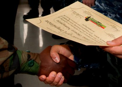 US Navy 110722-N-OV802-130 Cmdr. Angel Cruz shakes hands with Uganda navy Lt. Anna Namugwere during the Africa Partnership Station (APS) East Kenya
