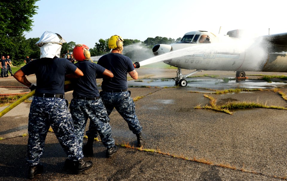 US Navy 110720-N-ZR940-001 Sailors aboard USS Harry S. Truman (CVN 75) spray down a training E-2C Hawkeye during routine aviation damage control tr