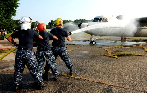 US Navy 110720-N-ZR940-001 Sailors aboard USS Harry S. Truman (CVN 75) spray down a training E-2C Hawkeye during routine aviation damage control tr