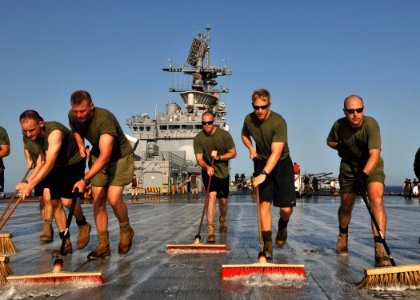 US Navy 110723-N-KA046-010 Marines assigned to the 22nd Marine Expeditionary Unit (22nd MEU) wash the flight deck of the multipurpose amphibious as