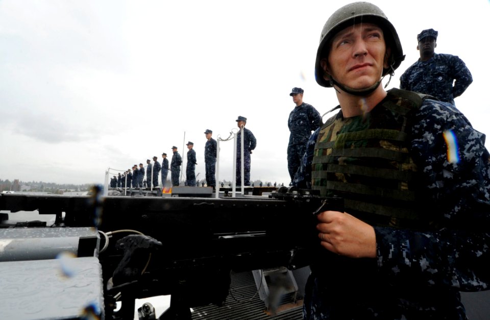 US Navy 110725-N-ZZ999-289 Aviation Ordnanceman Airman Don Dorland stands security watch while transiting Puget Sound aboard USS John C. Stennis (C