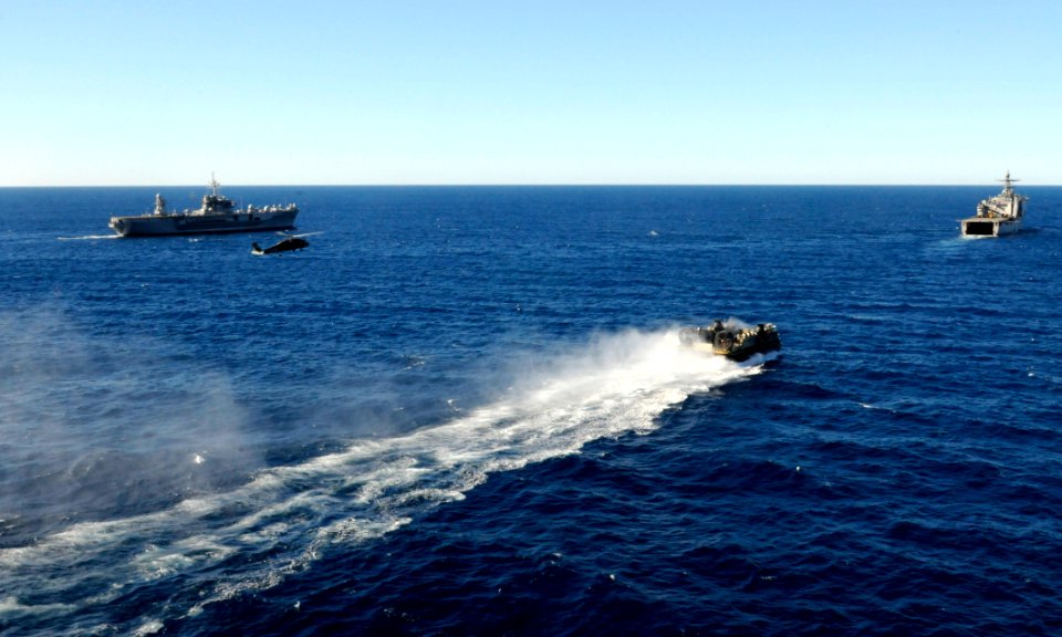 US Navy 110722-N-XG305-529 A landing craft air cushion returns to the amphibious dock landing ship USS Germantown (LSD 42) as the ship transits alo