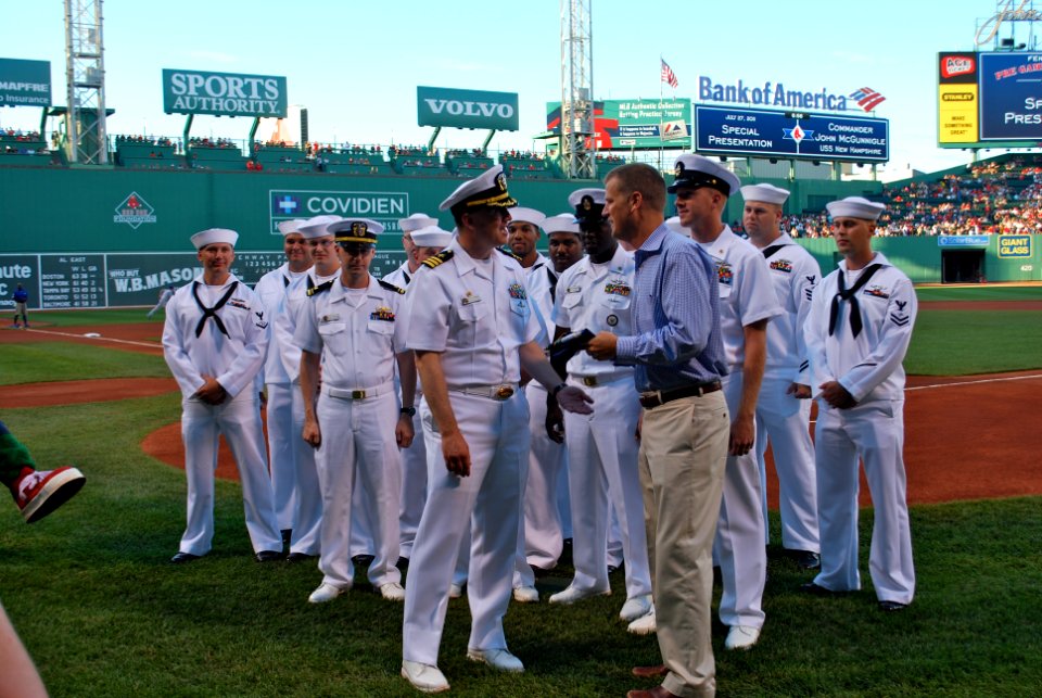 US Navy 110727-N-AW342-177 Cmdr. John McGunnigle presents Sam Kennedy the New Hampshire flag to fly over the park during the game