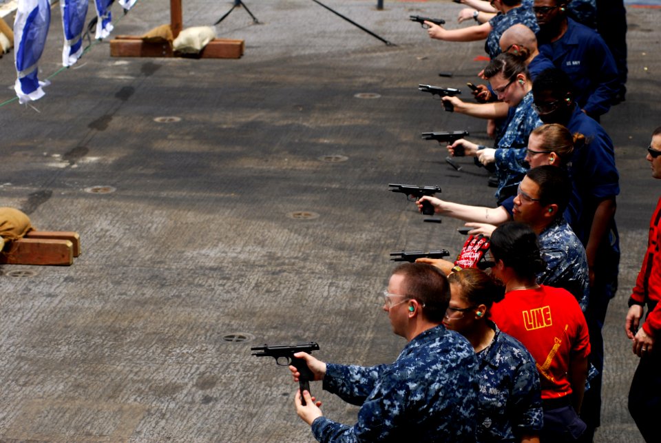 US Navy 110723-N-GL340-143 Sailors fire M-9 pistols during a small arms qualifications aboard the aircraft carrier USS Ronald Reagan (CVN 76)