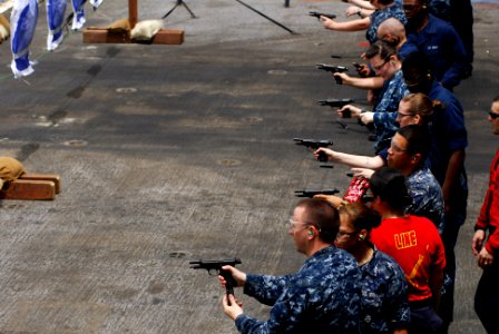 US Navy 110723-N-GL340-143 Sailors fire M-9 pistols during a small arms qualifications aboard the aircraft carrier USS Ronald Reagan (CVN 76) photo