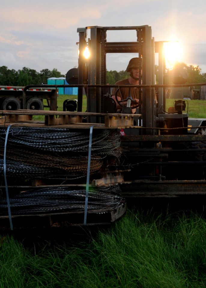 US Navy 110723-N-SD610-011 A Seabee assigned to (NMCB) 7 stages equipment for the battalion's move from its logistics supply area to their main bod