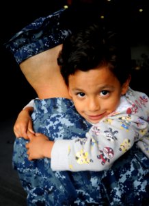 US Navy 110725-N-ZZ999-143 Chief Hospital Corpsman Rodel Salazar hugs his son aboard USS John C. Stennis (CVN 74) before getting underway