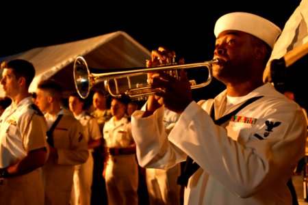 US Navy 110727-N-CZ945-061 Musician 3rd Class Michael Bookman plays the trumpet while performing the song Echo Taps at a Big Top reception aboard U photo
