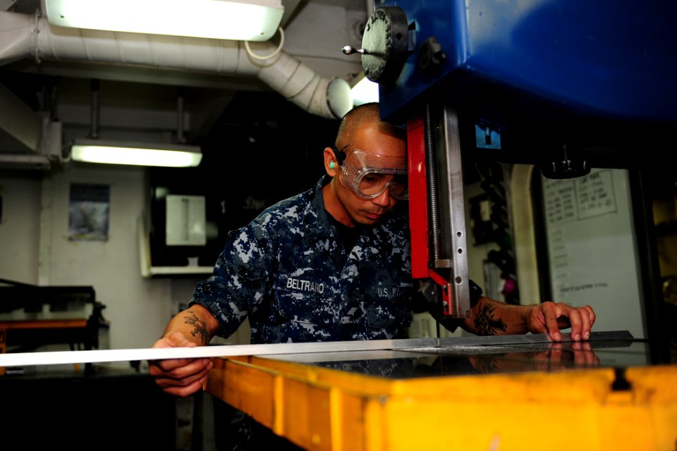 US Navy 110726-N-OI955-115 Aviation Structural Mechanic Airman Donald Beltrano saws through structural beams aboard the Nimitz-class aircraft carri