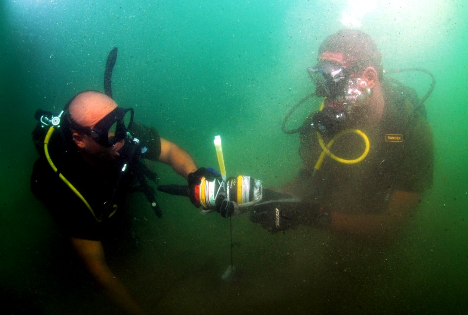 US Navy 110728-N-XD935-195 Able Body Seaman Raynaldo Farquharson, left, and Able Body Seaman Omar Albury find an inert training mine on the sea flo