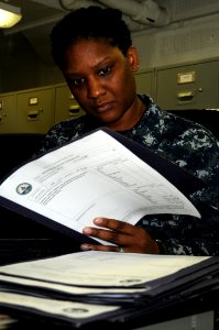 US Navy 110726-N-TU894-007 Yeoman 1st Class Delores A. Brundge reviews interdepartmental communication aboard USS George H.W. Bush (CVN 77)