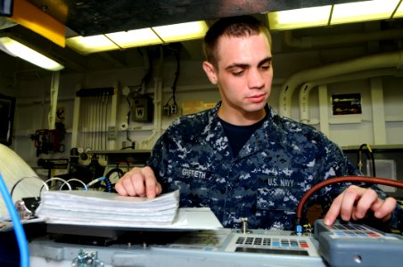 US Navy 110727-N-NB544-014 Aviation Electronics Technician Airman Mark Griffieth calibrates an air data test set calibrator aboard USS Ronald Reaga photo
