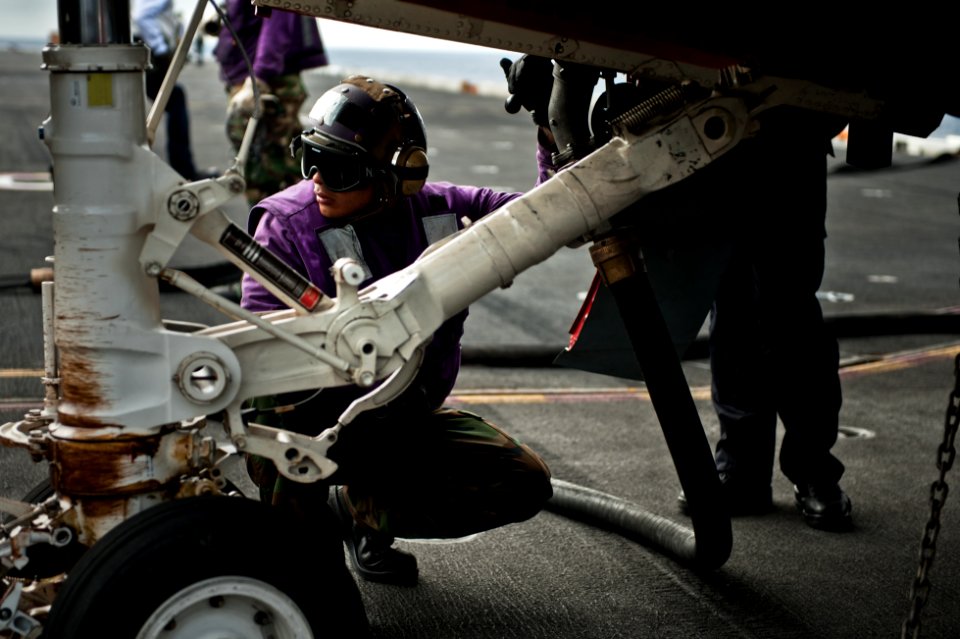 US Navy 110729-N-BT887-158 Aviation Boatswain's Mate (Fuel) Airman Michael Zaragoza refuels an EA-6B Prowler aboard USS John C. Stennis (CVN 74)