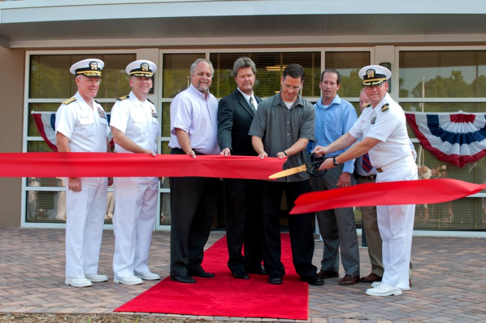 US Navy 110722-N-YT963-366 Rear Adm. Donald P. Quinn, left, commander of Naval Personnel Command, and key sponsors assist commanding officer Cmdr