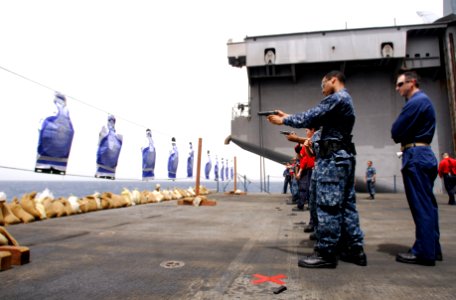 US Navy 110723-N-GL340-062 Sailors fire M-9 pistols during a small arms qualifications aboard the aircraft carrier USS Ronald Reagan (CVN 76) photo