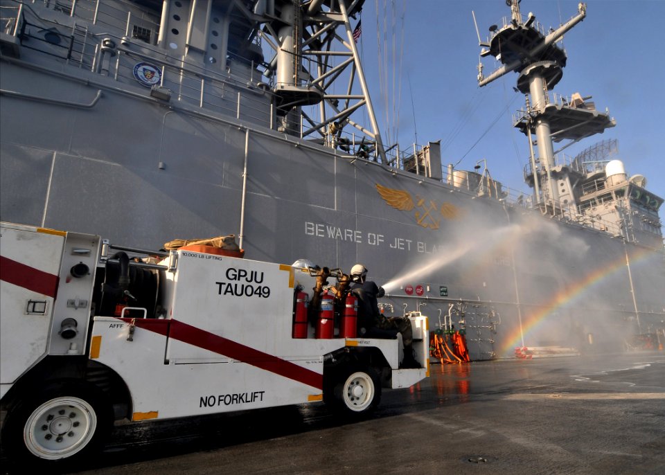US Navy 110723-N-KA046-014 Sailors use a P25 fire truck to wash down the superstructure of the multipurpose amphibious assault ship USS Bataan (LHD