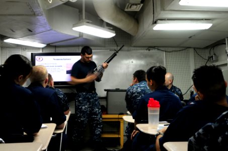 US Navy 110723-N-SB672-012 Master-at-Arms 2nd Class Anthony Soto instructs Sailors on M-16 handling requirements during a Security Reaction Force-B photo