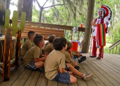 US Navy 110726-N-UA460-053 Cub Scout Master Glynn Wood, right, speaks to a group of Cub Scouts about Native American culture and customs during a C