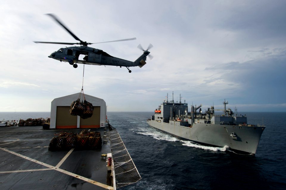 US Navy 110726-N-RM525-342 An MH-60S Sea Hawk helicopter transfers cargo from USNS Comfort (T-AH 20) to USNS Lewis and Clark (T-AKE 1)