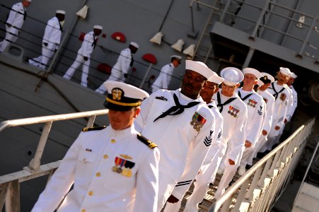 US Navy 110729-N-YR391-012 Sailors assigned to USS Doyle (FFG 39) disembark the ship for the last time during the ship's decommissioning ceremony a