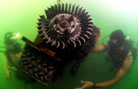US Navy 110727-N-XD935-253 Navy Diver 3rd Class Bryan Myers, right, and Jorge Mario Sanchez maintain positive control of an engine used for underwa
