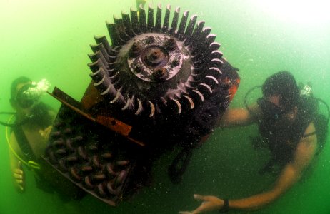 US Navy 110727-N-XD935-253 Navy Diver 3rd Class Bryan Myers, right, and Jorge Mario Sanchez maintain positive control of an engine used for underwa photo