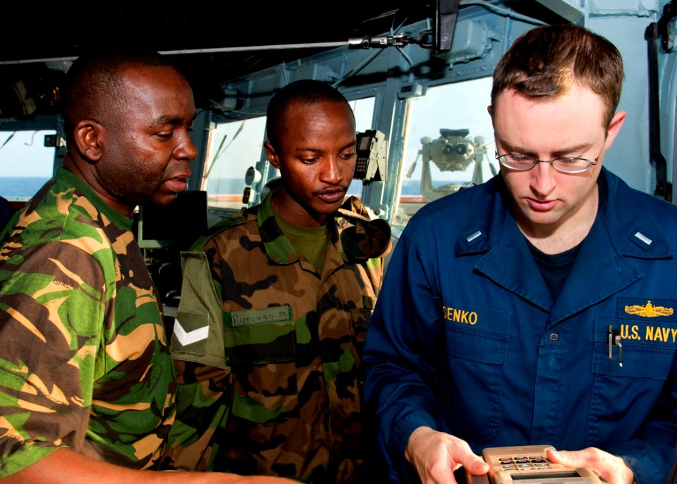 US Navy 110725-N-OV802-018 Lt. j.g. Brian Senko instructs Tanzanian navy Capt. A.M. Kihula and Lance Cpl. S.K. Rutungu on the bridge of USS Samuel