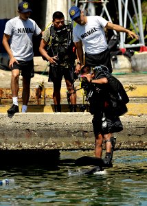 US Navy 110727-N-KB666-108 Deyner Salazar enters the water to conduct lift bag operations with Mobile Diving and Salvage Unit (MDSU) 2