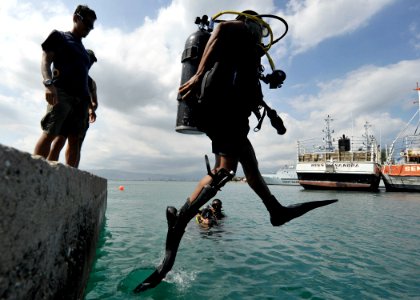 US Navy 110727-N-KB666-379 Arnulfo Lopez conducts a front step entry prior to search operations with Mobile Diving and Salvage Unit (MDSU) 2