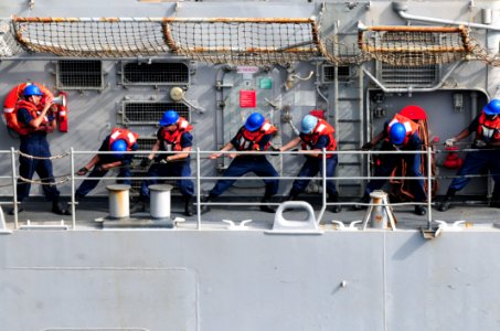 US Navy 110728-N-SB672-323 Sailors assigned to the guided-missile cruiser USS Chancellorsville (CG 62) heave lines to connect a fuel probe during a
