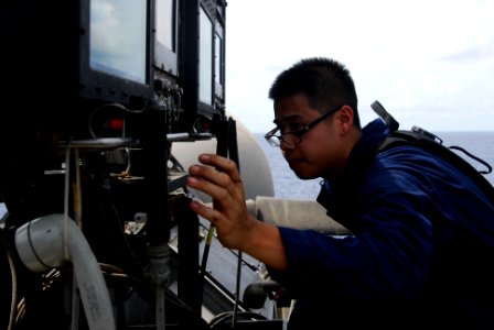 US Navy 110801-N-GL340-302 Interior Communications Electrician Fireman Billy Vilaiphanh, from Charlotte, N.C., inspects the landing signal officer