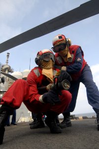 US Navy 110730-N-DU438-085 Damage Controlman 1st Class Peter Martinez, right, instructs Hull Maintenance Technician Fireman Michael Johnson