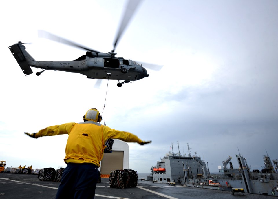 US Navy 110726-N-NY820-164 An MH-60S Sea Hawk helicopter transfers cargo from USNS Comfort (T-AH 20) to USNS Lewis and Clark (T-AKE 1)