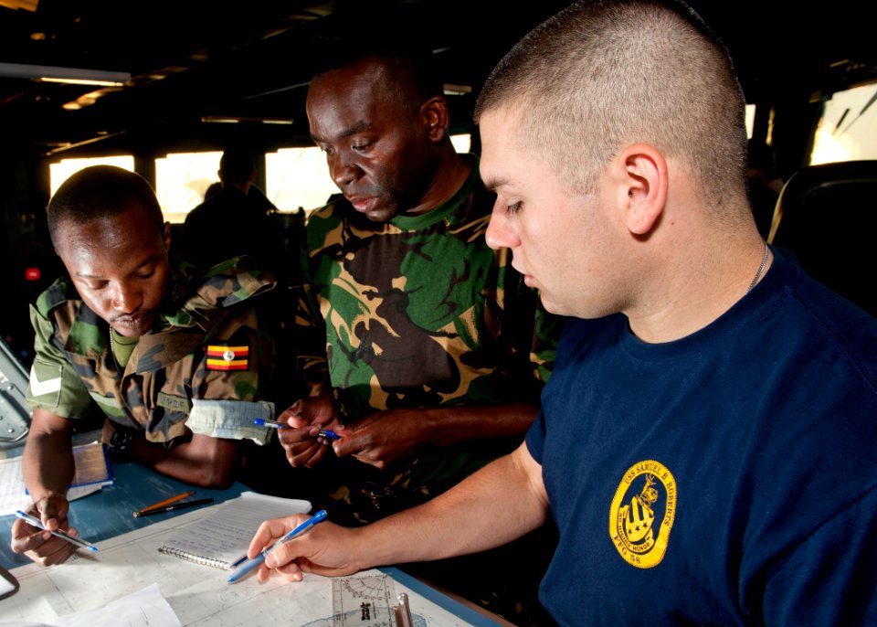 US Navy 110726-N-OV802-018 Quartermaster Seaman Kyle Seaux, right, instructs Tanzanian navy Capt. A.M. Kihula, center, and Lance Cpl. S.K. Rutungu