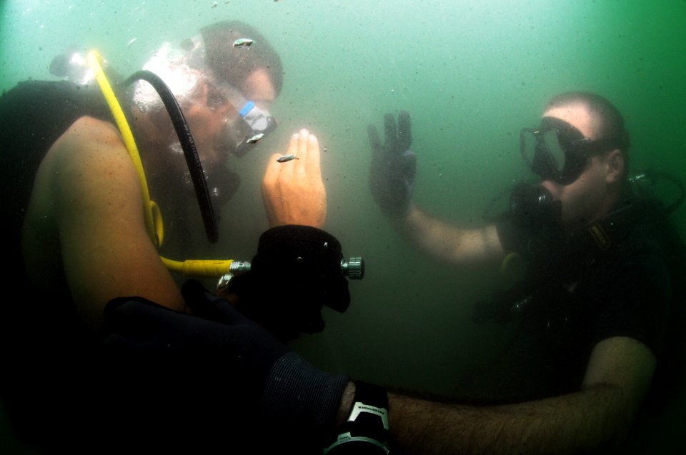 US Navy 110728-N-XD935-113 Chief Hospital Corpsman Nathanael Warren exchanges okays Guatemalan navy diver Antonio Sosa with during joint diving sea