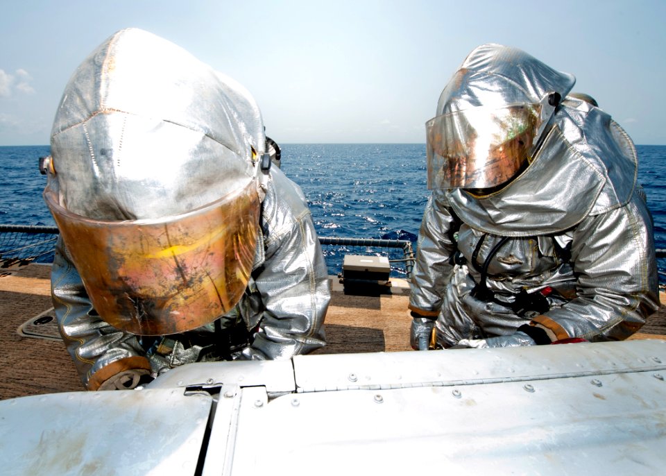 US Navy 110726-N-OV802-162 Yeoman Seaman Anthony Williams and Damage Controlman Fireman Paul Bernal wear hot suits while participating in a damage