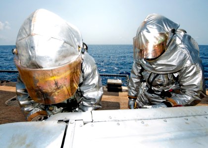 US Navy 110726-N-OV802-162 Yeoman Seaman Anthony Williams and Damage Controlman Fireman Paul Bernal wear hot suits while participating in a damage photo