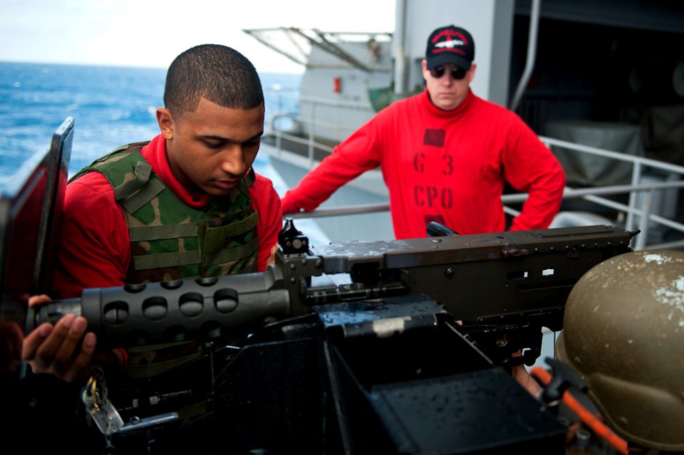 US Navy 110731-N-BT887-050 Aviation Ordnanceman Airman Hector Espinos assembles a .50-caliber machine gun during a training exercise aboard USS Joh