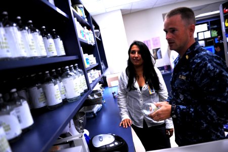 US Navy 110727-N-YR391-011 Lt. William Martin, a pharmacist at Naval Hospital Jacksonville, takes Zoe Sieber, a college preparatory medical arts ma photo