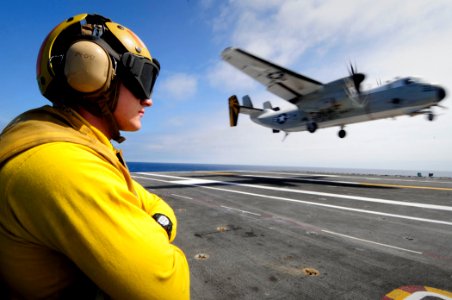 US Navy 110729-N-ZZ999-463 Aviation Boatswain's Mate (Handling) 2nd Class Kyle Kraus observes flight operations aboard USS John C. Stennis (CVN 74)