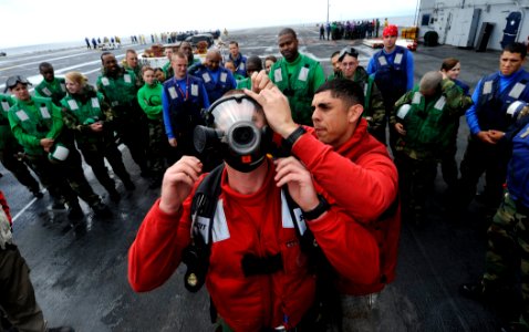 US Navy 110726-N-ZZ999-179 Aviation Boatswain's Mate (Handling) Airman Ty Alexander, right, and Aviation Boatswain's Mate (Handling) Airman Jeffrey