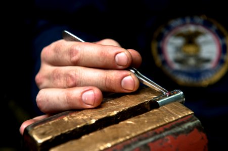 US Navy 110803-N-BT887-024 Machinery Repairman 3rd Class Chris Smigielski, from Daytona Beach, Fla., adds pins to a lock aboard the Nimitz-class ai