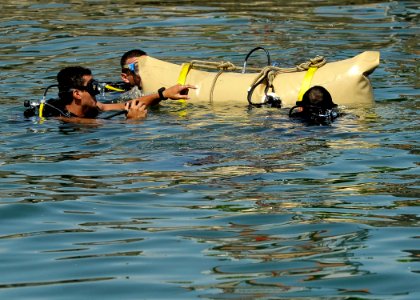US Navy 110727-N-KB666-084 Navy Diver 3rd Class Bryan Myers, left, assists divers assigned to the Guatemala navy in lift bag procedures photo