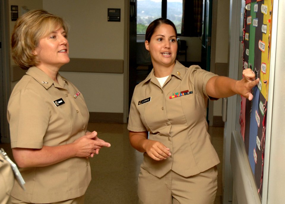 US Navy 110729-N-HJ915-122 Rear Adm. Elizabeth Niemyer, left, receives a brief on a process improvement board from Lt. j.g. Tarah Lewis
