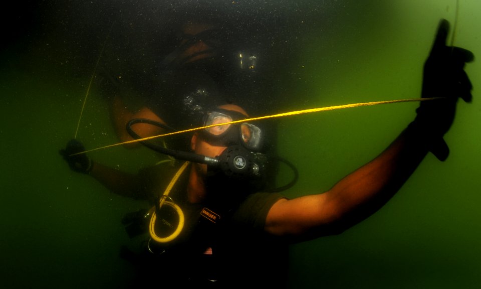 US Navy 110729-N-XD935-032 Royal Bahamas Defense Force diver Marine Seaman Verron Charlton conducts a security sweep on the bottom of a Jamaican Co
